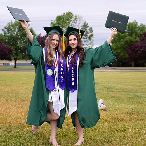 College staff and volunteers helping guide graduates before the event