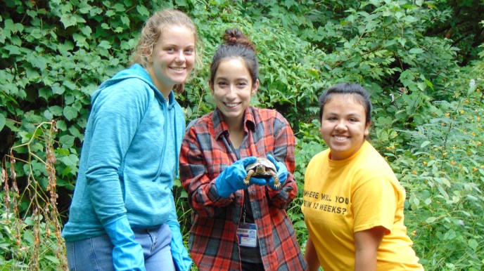 Students holding turtle