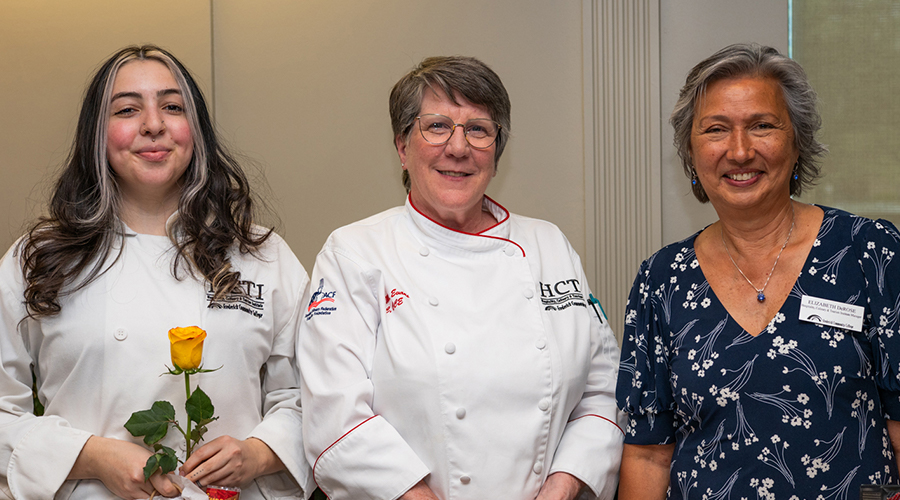 ​2 HCTI students and Elizabeth DeRose, Director