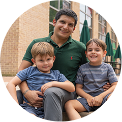 Cristian Vidal with 2 children on lap