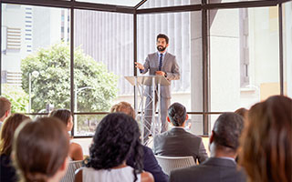 man at podium giving lecture