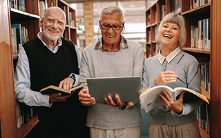 3 people with books in a library