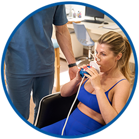 woman breathing into metabolic testing equipment